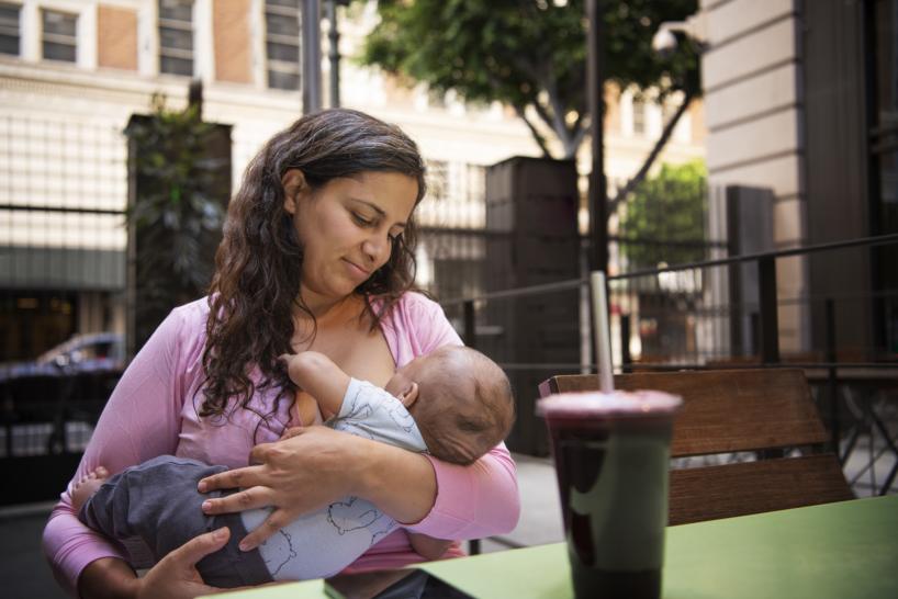 medium shot smiley woman holding baby